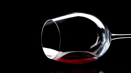 Wine glass. Red Wine reflection on a black glass table. Alcohol Grapes drink. Classic or traditional wine glass.