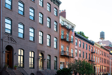 Block of old historic brownstone buildings in the Chelsea neighborhood of Manhattan in New York City