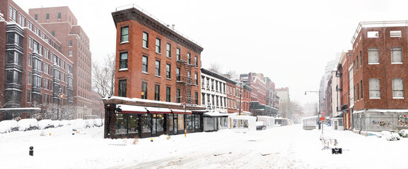 Snow covered street scene on Greenwich Avenue in the West Village of New York City after winter...