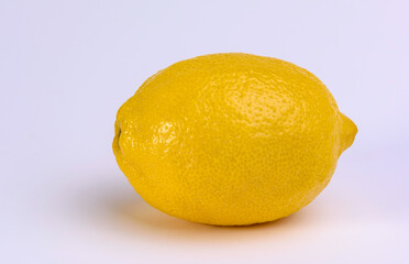A single yellow lemon on a white background