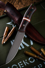Cartridge for shotgun shells and hunter's knife with sheath.