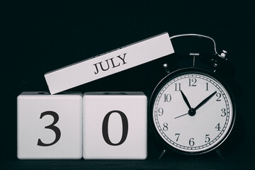 Important date and event on a black and white calendar. Cube date and month, day 30 July. Summer season.