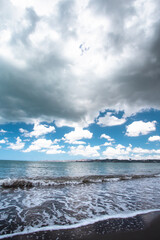 Dark storm clouds over Beautiful black sand beach and ocean at shoreline seen from Puerto Rico