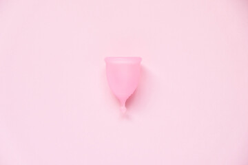 Menstrual cup on pink background. Alternative feminine hygiene product during the period. Women health concept