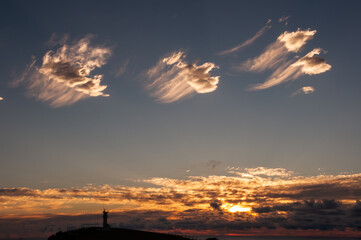 .The sunrise at Cape Agarizaki with three cirrus clouds composing the morning scene. Yonaguni Island.
