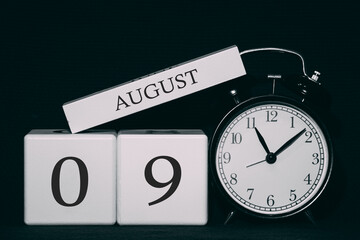 Important date and event on a black and white calendar. Cube date and month, day 9 August. Summer season.