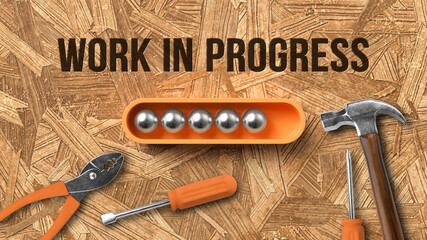 stylized loading bar with message WORK IN PROGRESS and handyman tools on wooden background