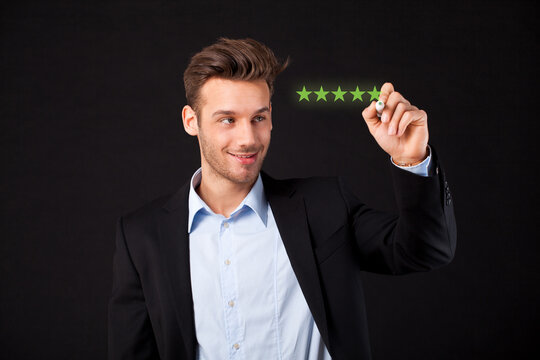 businesswoman writing 5 stars on a virtual screen in front of black background