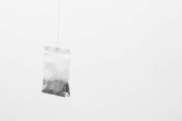 Tea bag on gray background.