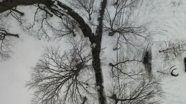11,286 - Aerial Birds Eye View of a Walking and Bike Trail at a Snow Covered Park