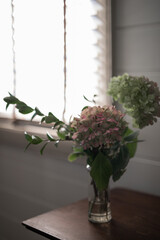 Vase of flowers lit by natural light