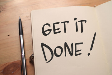 Get it done, text words typography written on book against wooden background, life and business...