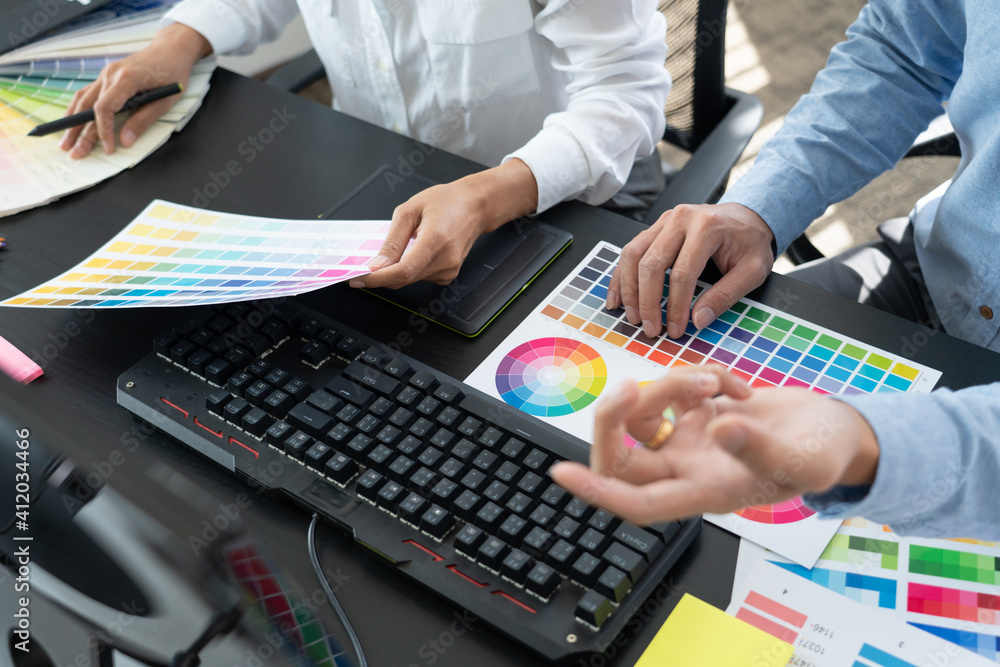 Aufkleber graphic designer or creative working together coloring using graphics tablet and a stylus at desk wi