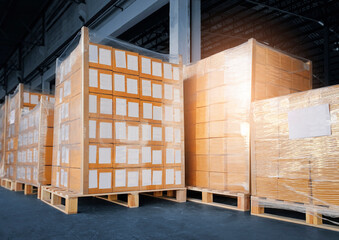 Stacked of cardboard boxes wrapped plastic film on pallet rack.  shipment boxes. cargo export. warehouse storage. 