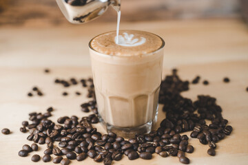 Cream dropping on a Coffee latte glass with grains 