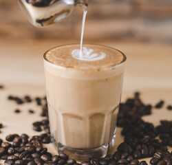 Cream dropping on a Coffee latte glass with grains 