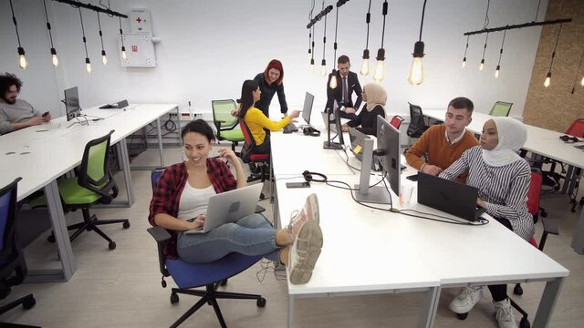 Multicultural group of business people and software developers working as a team in office