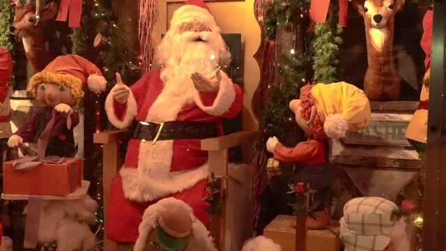 View of Santa Clause and His Elves at a Christmas House