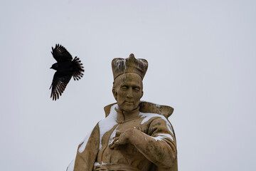 view of snow-covered statues and street lights on old stones Charles Bridge on the Vltava River in winter in the center of the town
