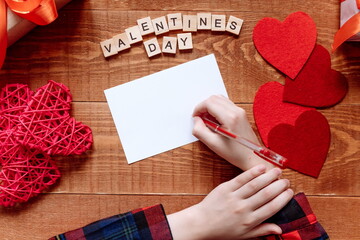 Girl s hand writes card letters holiday love Valentines Day