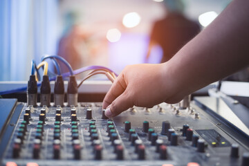 Hand of Man are controlling the console of sound system.