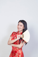 woman wearing cheongsam dress holding fan