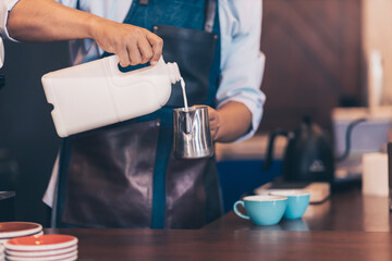 Barista making cappuccino, bartender prepare coffee drink at coffee shop .