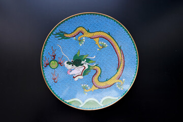 Obraz na płótnie Canvas Antique fine art blue metal enamel decorative plate with dragon motive Lunar calendar new year concept