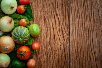 different fruits and vegetables on brown wooden table background. Copy space.