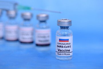 Russian vaccine and Healthcare Medical concept. Vaccines and syringe on blue background for prevention,immunization and treatment from corona virus infection