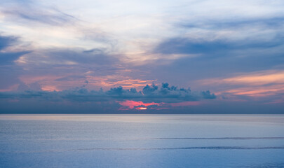 The atmosphere of the sea is calm and beautiful in the morning when the sun rises, making it look like heaven.