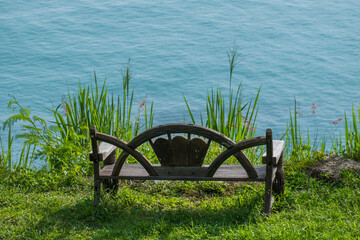A chair at the viewpoint on the hill overlooking the sea as calm and beautiful as heaven.