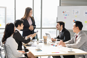 A Group of diverse businesspeople, Asan and Caucasian, make a conference together at the desk. Idea for good team at workplace