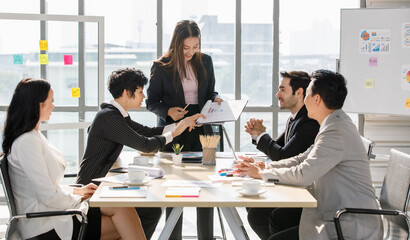 A Group of diverse businesspeople, Asan and Caucasian, make a conference together at the desk. Idea for good team at workplace