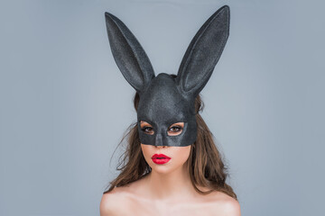 Easter bunny woman in black lace mask. Egg hunt. Rabbit ears.