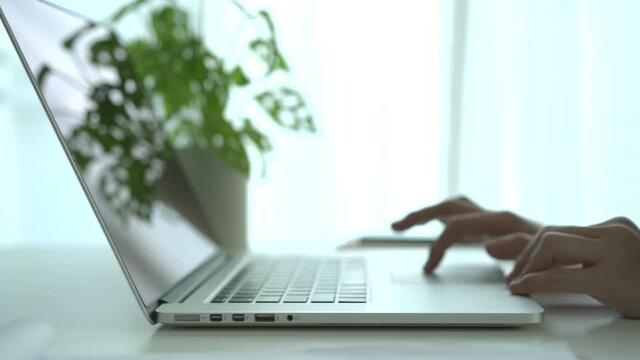 Woman using laptop computer for online meeting