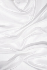 Fototapeta na wymiar Texture of white silk cloth, textile background, drapery and pleats on delicate fabric.