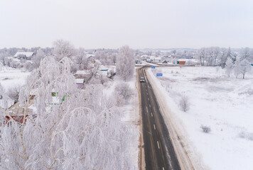 Road in the village in winter..
