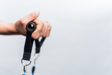 Focus hands catching an exercise rope on a white background with copy space. Concept of exercise and fitness girl.