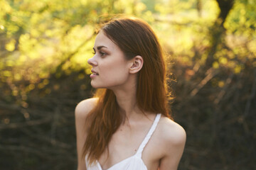 woman travels on nature in forest white sundress cropped view