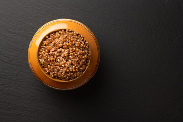 buckwheat porridge cooked in a clay pot in the oven, flat lay