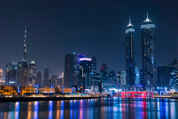 Obraz premium Amazing Dubai City Skyline at Night or Blue Hour. View from Dubai water canal business bay, United Arab Emirates.