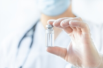 Ampoule with medicine in doctor's hand - vaccination