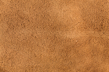 leather grunge background: an old piece of tough camel skin, with scuffs, spots, scars
