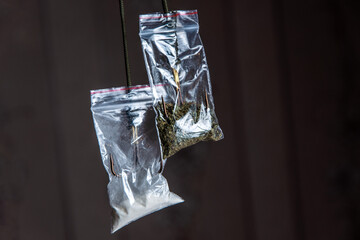 drug trap concept: a pair of drug sachets with triple hooks inside