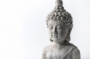 Fototapeta na wymiar Meditating Buddha Statue on bright wooden background. Copy space.