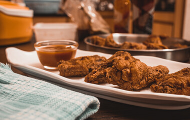 Homemade fried chicken wings and dip sauce on a platter