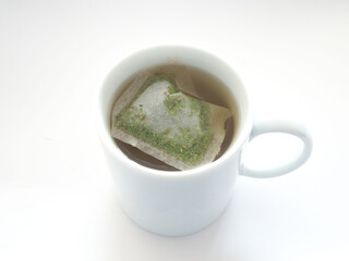 Healthy herbal tea is brewed in a mug on a white background. Strengthening the immune system with herbs.