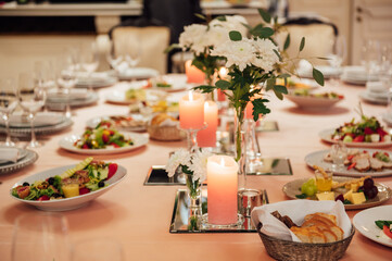 Luxurious restaurant. Luxurious interior, white tables, serving dishes and glasses for guests