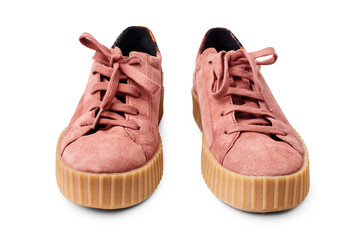 Light red suede sneakers white background isolated close up front view, stylish pink chamois...